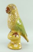 EWENNY POTTERY MODEL OF A PERCHED PARROT in red slip with sgraffito and yellow, brown and green over