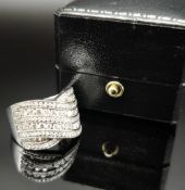 18CT WHITE GOLD DIAMOND CROSS BAND RING, channel set, ring size J, 7.6gms Provenance: private colle