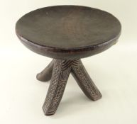 IGBO STOOL, Nigeria, dished circular seat above pierced and carved splayed legs, 29cms diameter