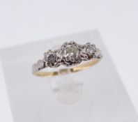 18CT GOLD & PLATINUM THREE-STONE DIAMOND RING, the illusion set diamonds totalling 0.4cts overall