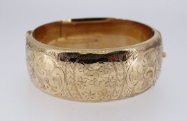9CT GOLD BANGLE, scroll engraved, 33.0gms