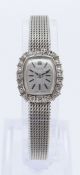 18CT WHITE GOLD TISSOT LADIES WRISTWATCH, the silvered dial having baton markers and surrounded by