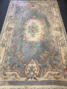 WASHED WOOLLEN CHINESE CARPET - light blue and cream ground with central floral cartouche and single