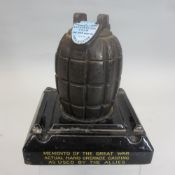 MILLS GRENADE MATCH STRIKER - mounted on a square black pottery stand, bearing the words 'Memento of
