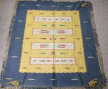 A MIDDLE EASTERN WALL HANGING - mid blue ground with a large gold silk effect panel having four