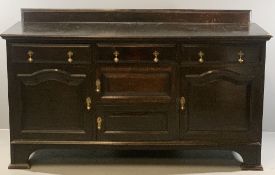 EARLY 20th CENTURY RAILBACK OAK SIDEBOARD of three frieze drawers, two slim central cupboard doors