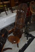 A traditional African palavar chair having carved detail to back of elephants