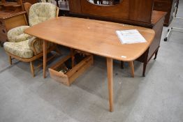 An Ercol light stain dining table, approx. 150 x 75cm