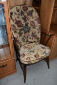 A traditional dark stained Ercol Windsor chair, having spindle frame
