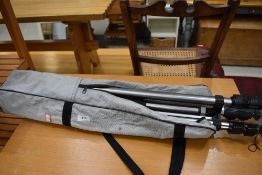 A camera tripod in carry bag