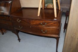 An early 20th Century mahogany dressing chest of two over one long draw, having bow front and