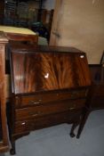 An early to mid 20th Century flame mahogany bureau on cabriole legs with ball and claw feet, width