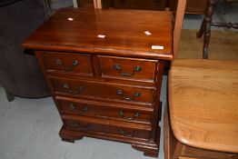 A modern hardwood dwarf chest of two over three drawers, width approx. 55cm