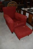 A Howard style chair of long narrow proportions and a similar footstool, later upholstery in red