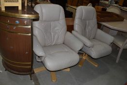 A pair of leather recliner armchairs, not Stressless, seats a bir perished
