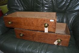 Two oak drawers with brass handles