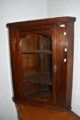 A traditional stained frame corner wall display cupboard