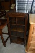 An early 20th Century oak narrow bookcase, width approx. 46cm, height 100cm