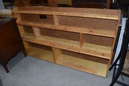 A pine and chipboard back low bookcase, width approx. 170cm