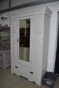 A later painted Victorian mirror door wardrobe, on drawer base, width approx. 133cm