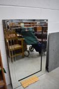 A modern frameless wall mirror, approx. 80 x 120 cm