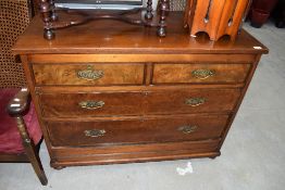 A 19th Century mahogany and walnut chest of two over two drawers, raised on semi bun feets and metal