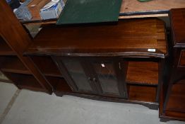 A reproduction Regency style low display unit with central display section flanked by shelves, width