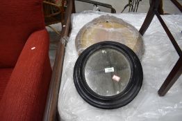 A small circular wall mirror and a gilt picture frame