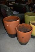 Two glazed clay planters and pots, largest being a height of 60cm
