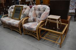A modern canework conservatory settee, chair and coffee table
