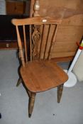 A traditional stained frame spindle and vase back kitchen chair