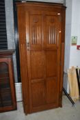 An early 20th Century traditional oak hall robe having linen fold and panelled doors, width