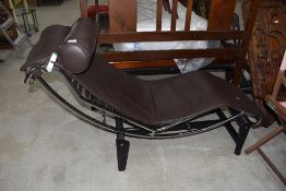 A modernist style chaise longue, having chrome frame, Le Corbusier design, brown leather upholstery