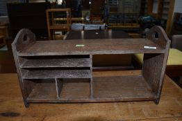 An Arts and Crafts style oak stationery rack, width approx. 46cm