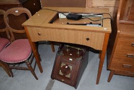 A vintage Singer sewing machine table with integral machine