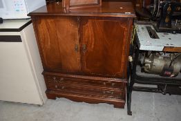 A reproduction mahogany TV cabinet, width approx. 80cm