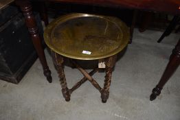 A small Indian brass tray table on stained barley twist frame