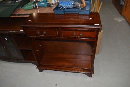 A reproduction Regency style low shelf unit with two frieze drawers, width approx. 76cm
