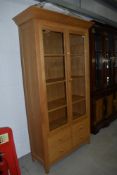 A nice quality golden oak display cabinet , retailed by Marks and Spencer, approx. dimensions W108cm
