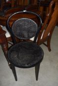 A traditional bentwood cane work chair, in black