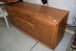 A mid stain Ercol sideboard, having central drawer section flanked by cupboards, width approx.