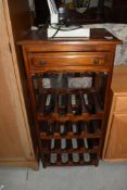 A modern hardwood wine rack (16 bottles) with frieze drawer