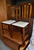 A pair of Edwardian mahogany and inlaid bedroom chairs having later Celtic style upholstered seats