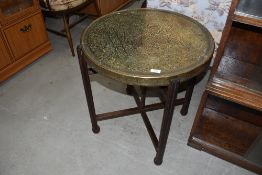 A traditional Indian brass circular table on wood frame, diameter approx. 60cm