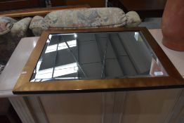 A modern bronze effect wall mirror, approx. 71 x 56cm