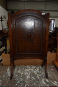 A mid 20th Century oak firescreen