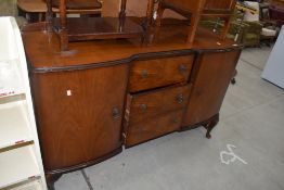 An early to mid 20th Century walnut breakfront sideboard on Queen Anne style cabriole legs, width