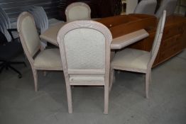 A modern octagonal table and 4 chairs in glossed limed oak and peach effect