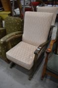 A pair of traditional stained frame and upholstered rocking chairs