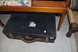 A vintage travel case having leather handle and straps, bearing part label